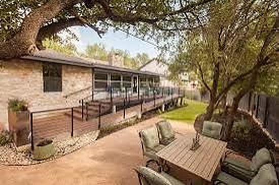 Shaded patio with outdoor seating under a live oak