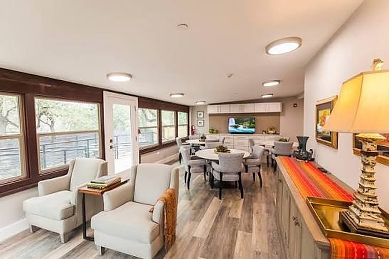 Sunroom with armchairs and tables where activities are held
